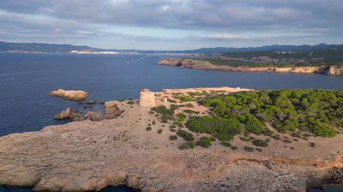 mediterranean coastal sunset ancient historic tower. Dramatic aerial top view flight drone shot foot