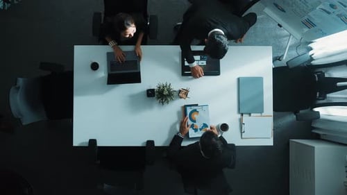 Top view of smart team walk at meeting table and start to discuss. Directorate.