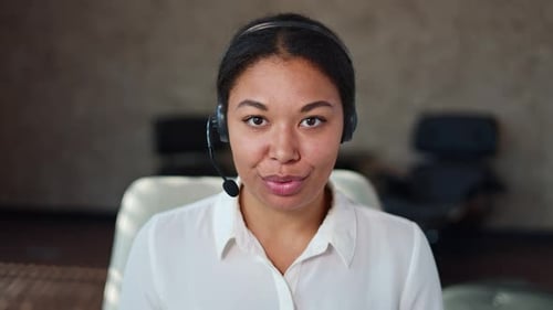 African American Woman in Headset Making Video Call During Working Day at Office