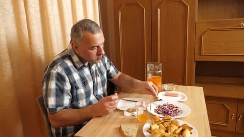 Man Having Meal at Table Indoors