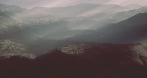 Mountains and Valleys Bathed in Morning Light with Misty Atmosphere