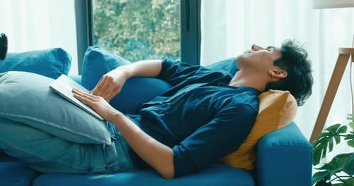 Young Adult Relaxing With Laptop on Couch