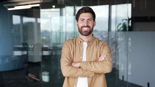 Smiling Man Poses Confidently in Modern Office