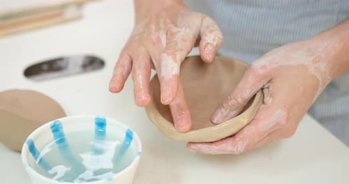 Woman Forming Clay Pot Shape By Hands Closeup in Artistic Studio