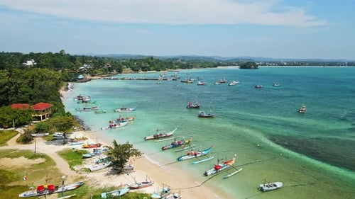 Aerial Reveals Vibrant Fishing Boats Anchored in Tranquil Azure Lagoon Coastal Scene Reflects