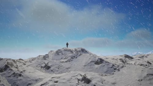 Person Standing On Top Of A Snow Covered Mountain. Cold Snowy Landscape Aerial