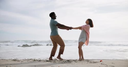 Couple, holding hands and spinning with love on beach, playful and travel adventure with romantic