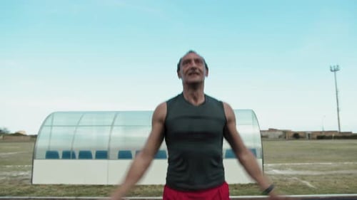 Sweating Athlete Doing Jumping Jacks