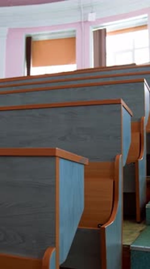 Empty seats in university classroom. Empty lecture hall with large amount of seats. Vertical video
