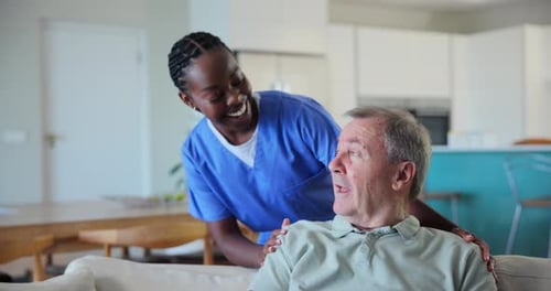 Caring Woman with Senior Man on Couch