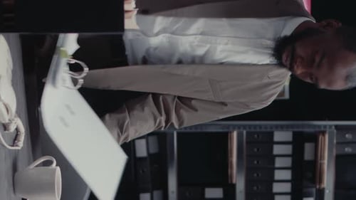 Man Reading Documents at Office Desk