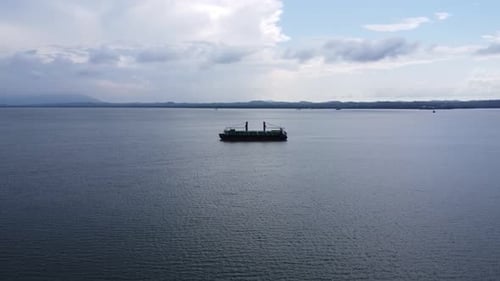 Aerial view of a large ship carrying containers in the Kalimantan sea, shipping containers