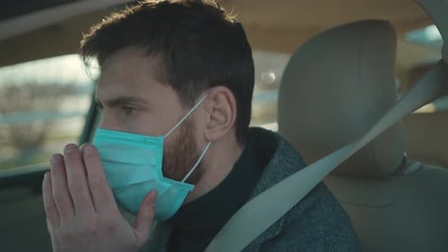 Man Driving Car Wearing Face Mask for Protection