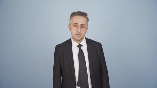 Mature Adult Grimaces in a Studio Setting