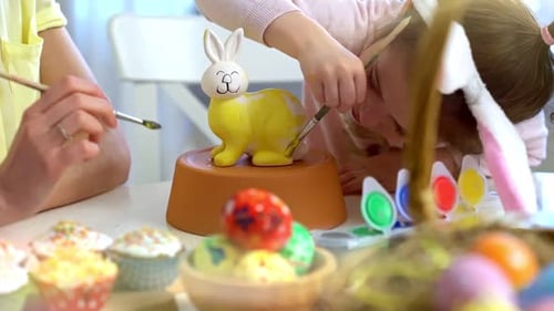 Mother and Daughter Paint a Ceramic Bunny Together for Easter