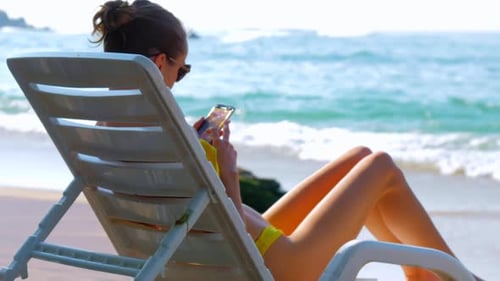Woman Relaxing on Beach Lounge Chair