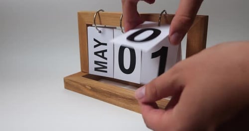 Hands Change the Date to May on Calendar