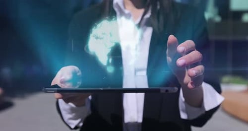 Woman Uses Tablet with Futuristic Global Data Display