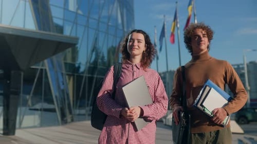 Young Classmates Standing Together in Front of Modern Glass Campus