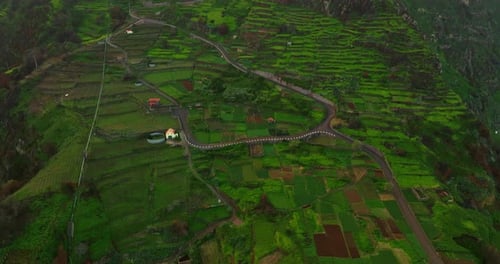 Drone Flying Above Countryside Landscape of Mountains and Agricultural Area Farmland in Tropical