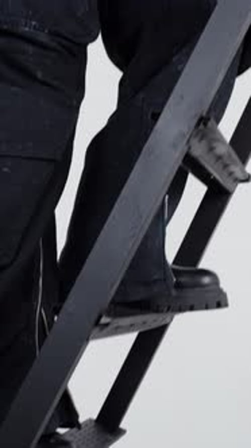 Person Climbing Metal Ladder on White Background