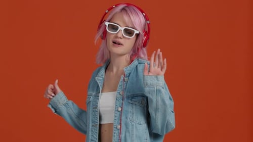 Young Modern Woman 20s in Stylish Denim Jacket and Cropped Top Chewing Gum