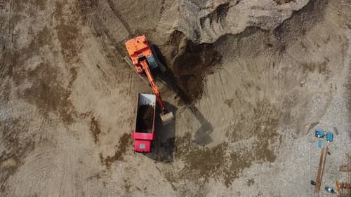 Excavator Loading Dump Truck From Birds Eye View