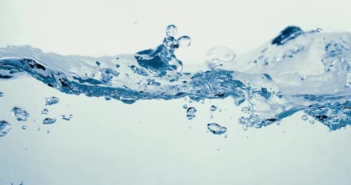 Many bubbles in water close up, abstract water wave with bubbles in slow motion