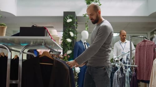 Modern Stylish Store Employee Helping a Client Explore Clothing Options