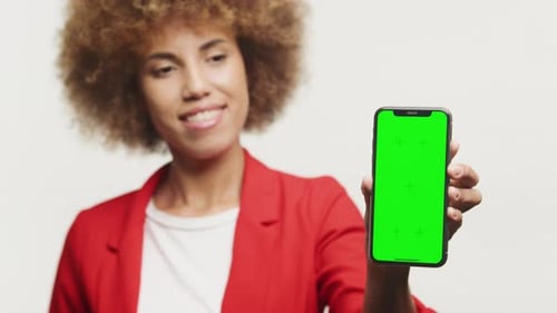 Businesswoman Showing Green Screen Smartphone on White