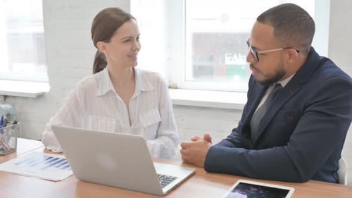 Businessman Talking with Businessman in Office