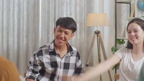 Young Adults Unite Hands Indoors at Home