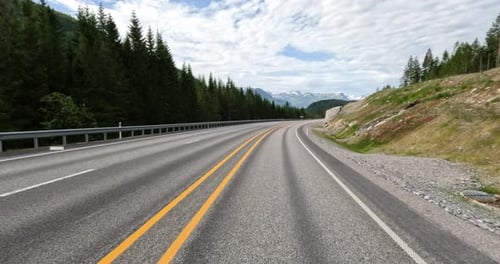 Driving a Car on a Road in Norway at dawn. Point-of-view driving
