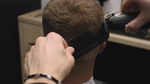 Man Getting Haircut in a Barber Shop