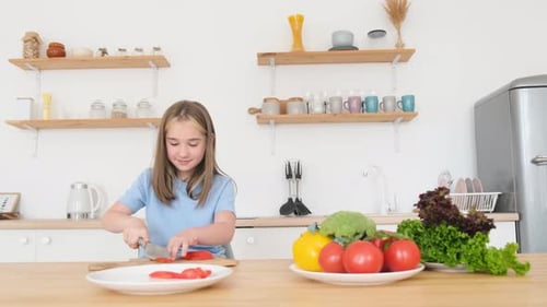 Girl Slicing Vegetables in Bright Kitchen