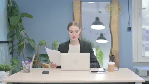 Young Woman Working on Laptop in Office