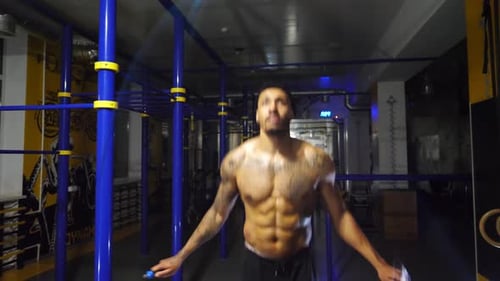 Strong African Athlete with Tattoos Skipping with a Jump Rope at Sport Club Young Black Sporty Man