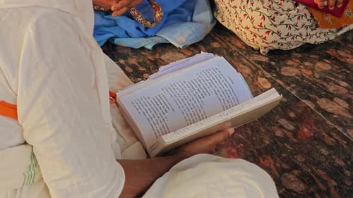 Senior Reads Holy Book Indoors During The Day