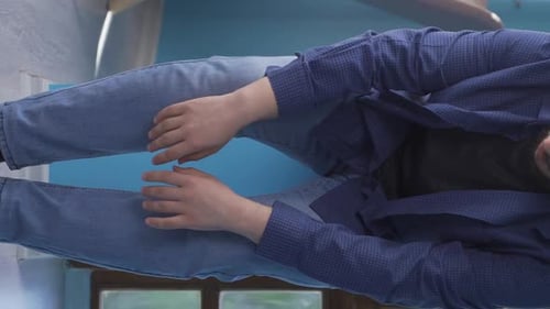 Distraught Man Sitting on Floor Hugging Knees