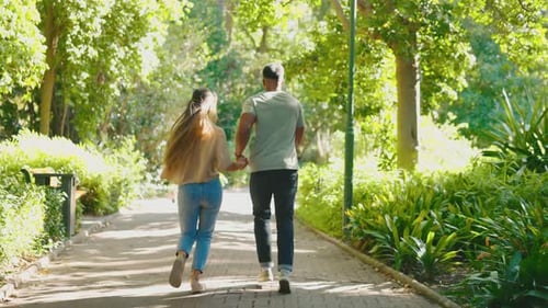 Happiness, park and couple running in a forest rail together on a date in nature