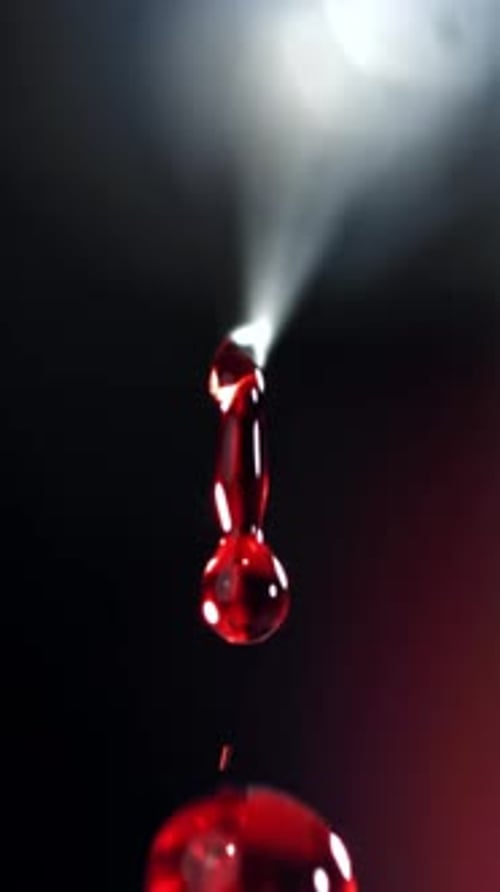A Drop of Blood From a Syringe Filmed on a Highspeed Camera at 1000 Fps