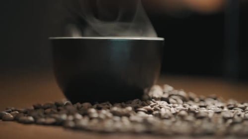 Steaming Coffee Mug on Coffee Beans