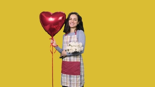 Female Florist Holding White Carnations and Red Air Balloon on the Yellow Chroma Key