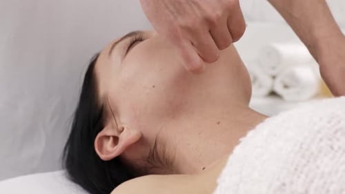 Woman Receives Facial Massage at a Spa