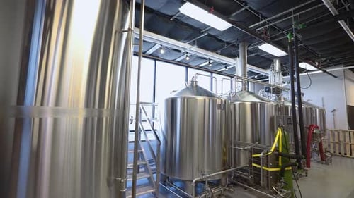 Brewery equipment in warehouse, stainless beer stills in working brewery, 4K