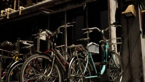 Bicycles Parked Outside a Shop on a Quiet Street in the Evening