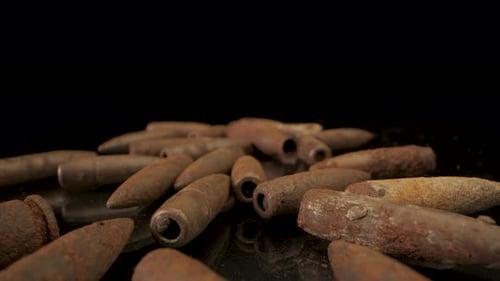 Closeup of Rusty Old Bullets on a Black Surface