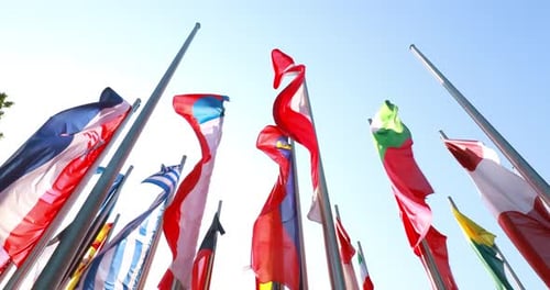 International Flags Fluttering in the Wind on Metal Poles