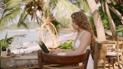 Female Developer Working on Laptop By the Ocean Young Woman Freelancer Coding at Outdoor Tropical