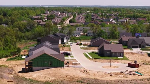 Aerial View of Suburban Houses Under Construction in an American Neighborhood Green Landscape and